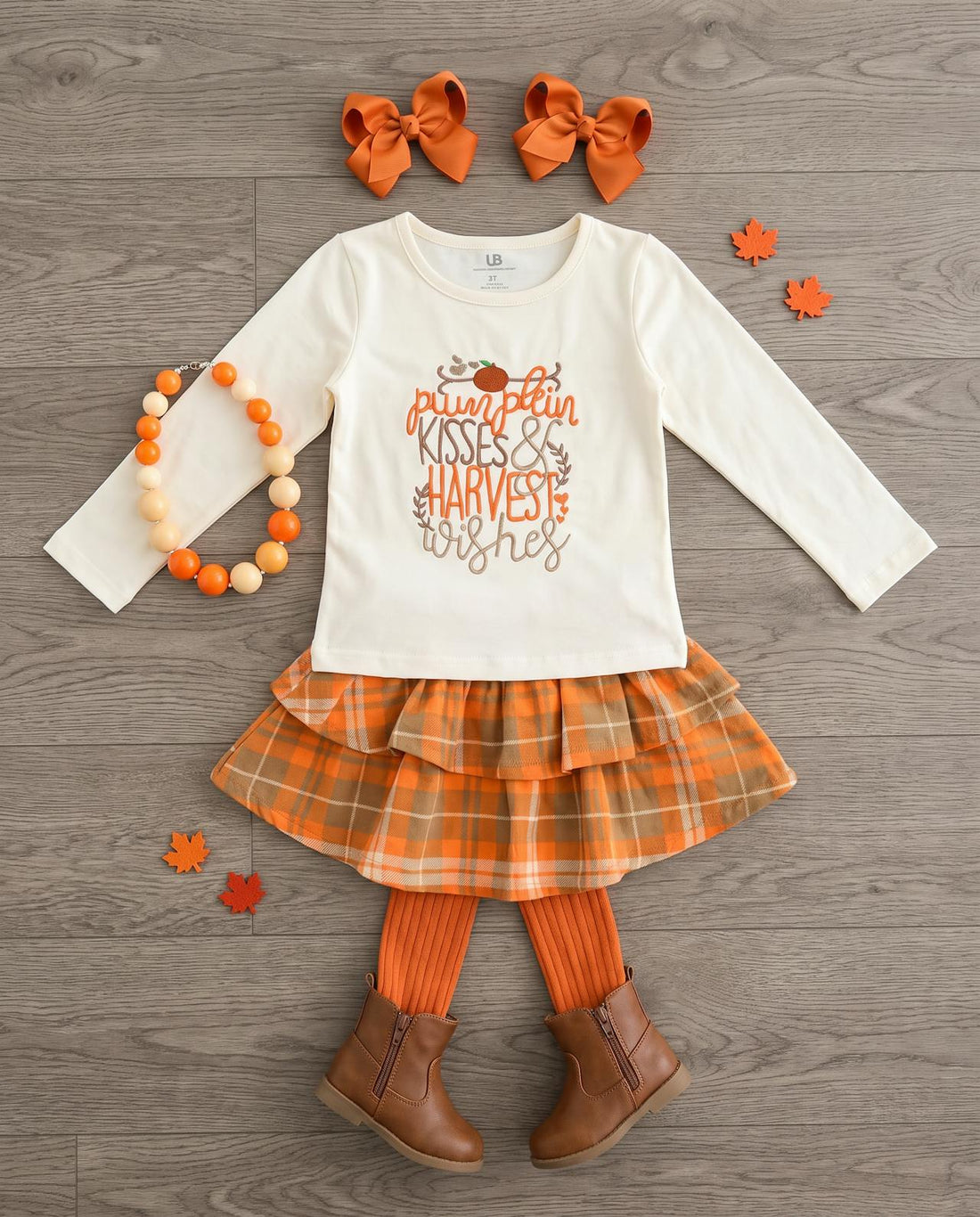 Pumpkin Kisses outfit laid flat with mini pumpkins